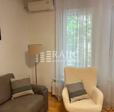 Living room with sofa, armchair and air conditioning unit. - image 10