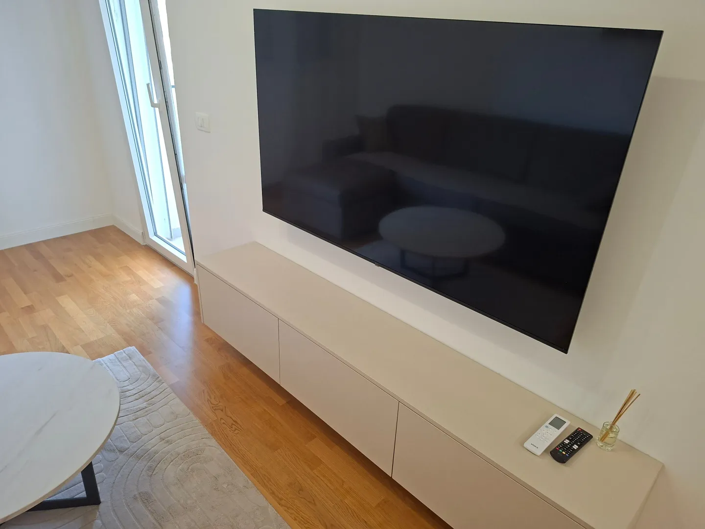 Living room with a TV and a media console.