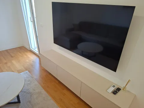 Living room with a TV and a media console. - image 7