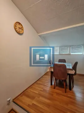 Dining area with a table, chairs, and a wall clock. - image 5