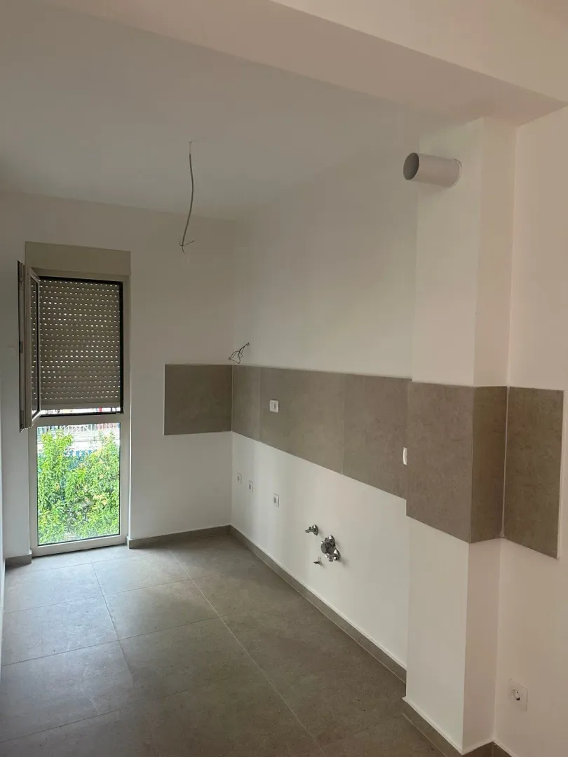 Unfurnished room with plumbing connections and a window.
