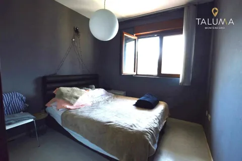 Bedroom with a bed and a window against a dark-painted wall. - image 3