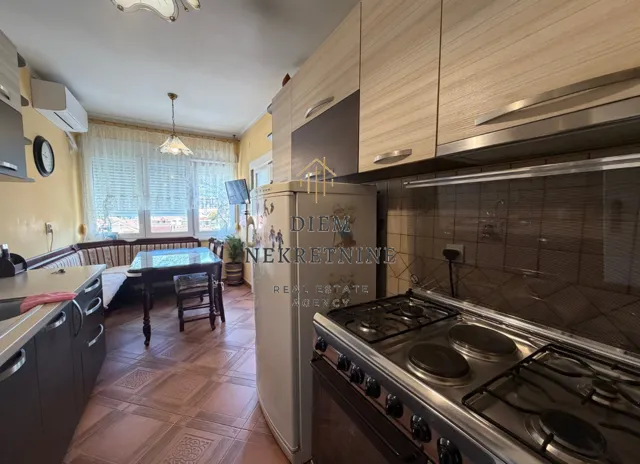 Kitchen with cabinetry and a dining area.