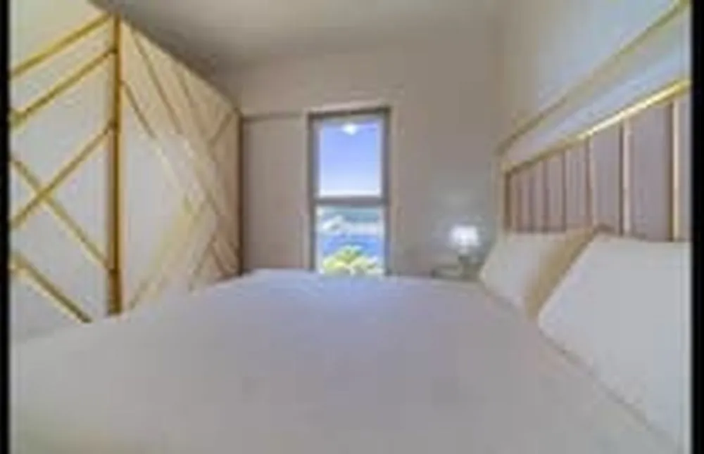 Bedroom with a double bed, large wardrobe and sea view.