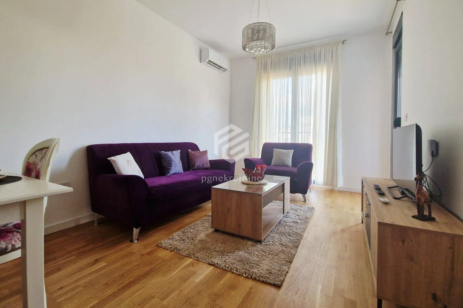 Living room with a sofa set and a television.