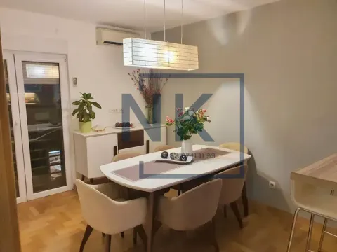 Dining area with a table, chairs, and a chandelier. - image 3
