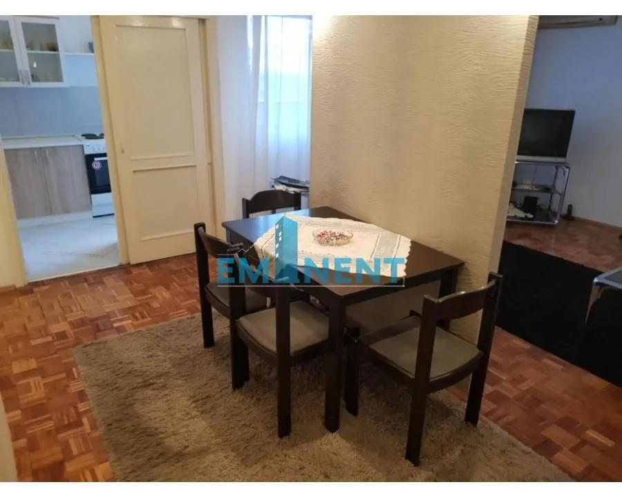Dining area with a table and chairs, overlooking the kitchen and part of the living room.