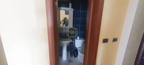 View through the doorway into a small bathroom with a sink and toilet. - image 8