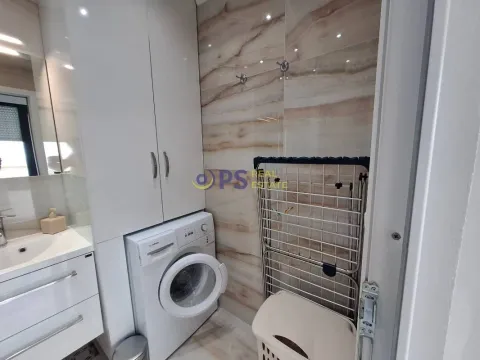 Modern bathroom with a washing machine and a cabinet. - image 3