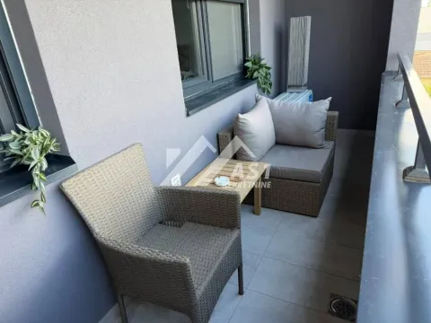 Small furnished balcony with a seating set and a small table. - image 2