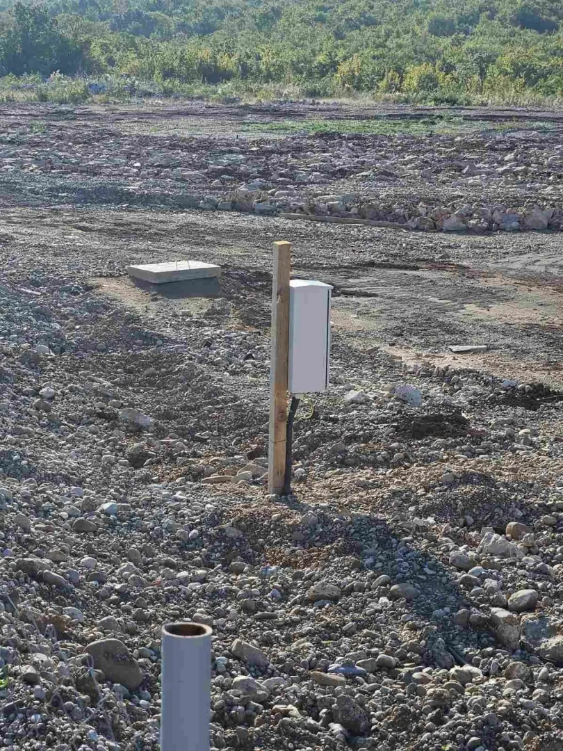 Building plot with an installed electricity connection box.