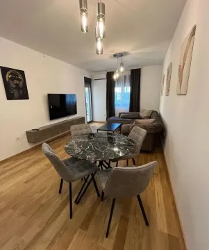 Living room with dining area, sofa, and TV. - image 3