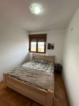 Furnished bedroom with a double bed and a window. - image 7