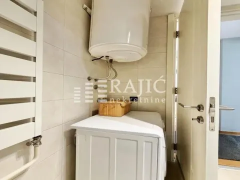 Smaller bathroom with a water heater and washing machine. - image 12