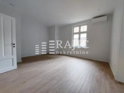 Empty room with light walls, wooden flooring, and an air conditioner. - image 14