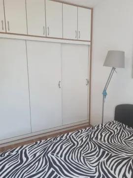 Bedroom with a large built-in wardrobe and a double bed. - image 11