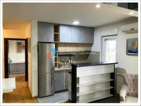 Kitchen with cabinetry and a bar counter connected to the living room. - image 5