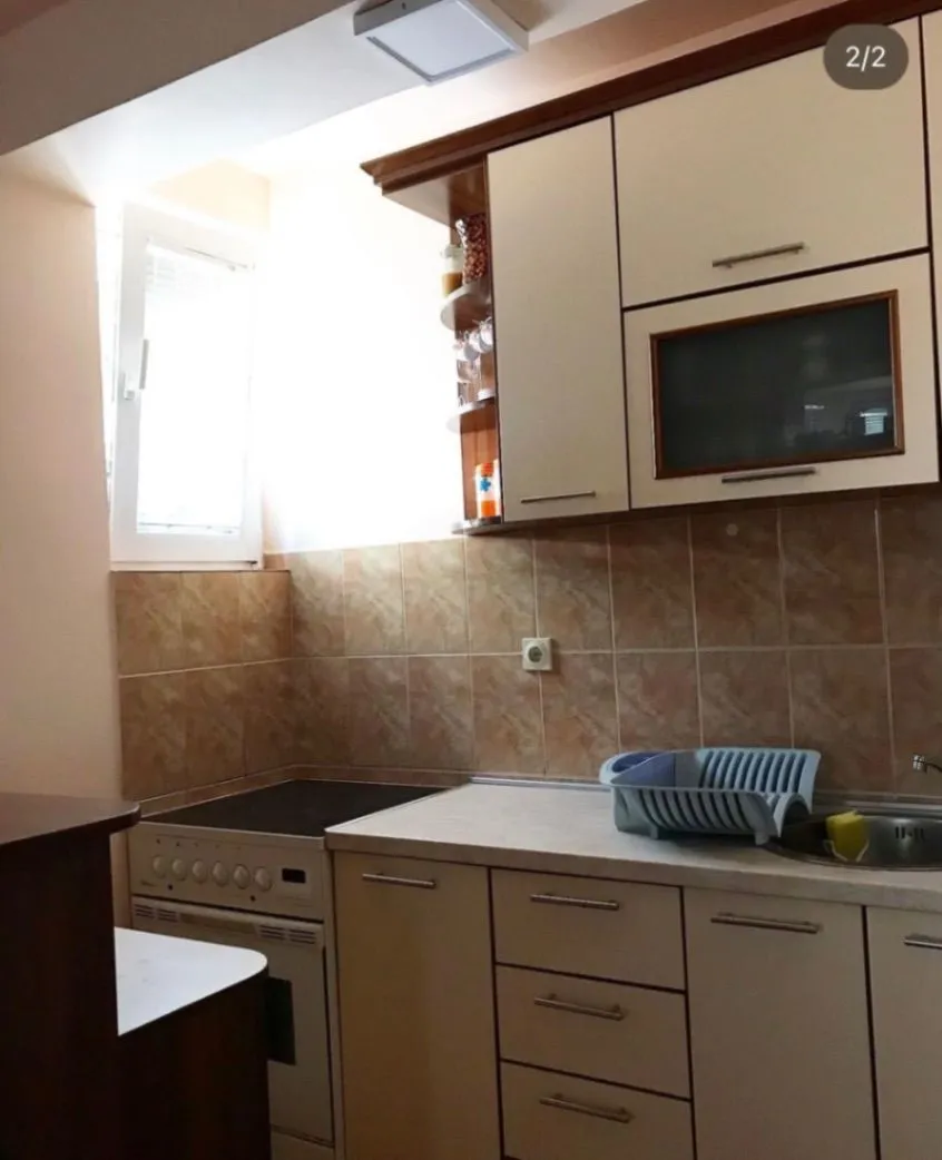 Small kitchen with cabinets and stove.