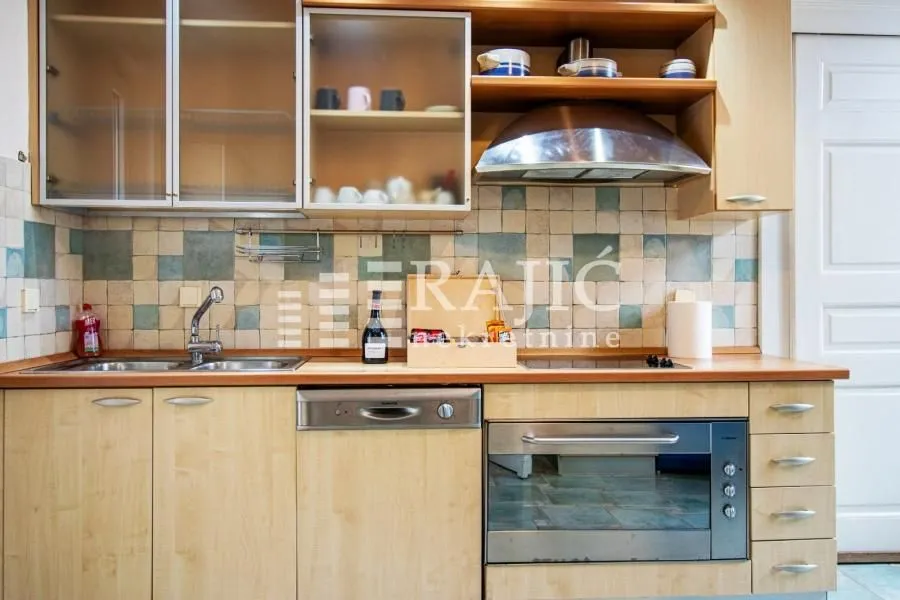 View of the kitchen with wooden cabinets and built-in appliances.