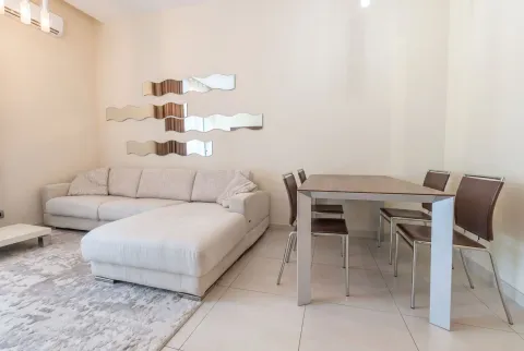 Spacious living room with a sectional sofa and dining table. - image 5