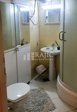 Smaller bathroom with a sink, toilet, and shower cabin. - image 6