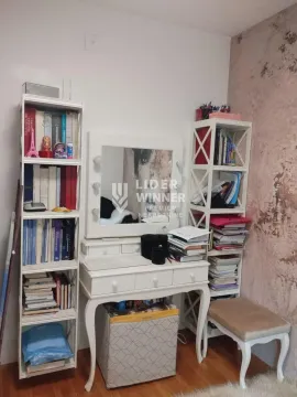 White desk with a mirror and bookshelves in the room. - image 19