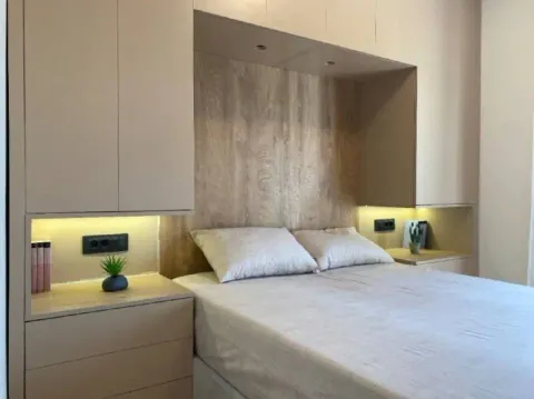 Modern bedroom with built-in wardrobe and bed. - image 6