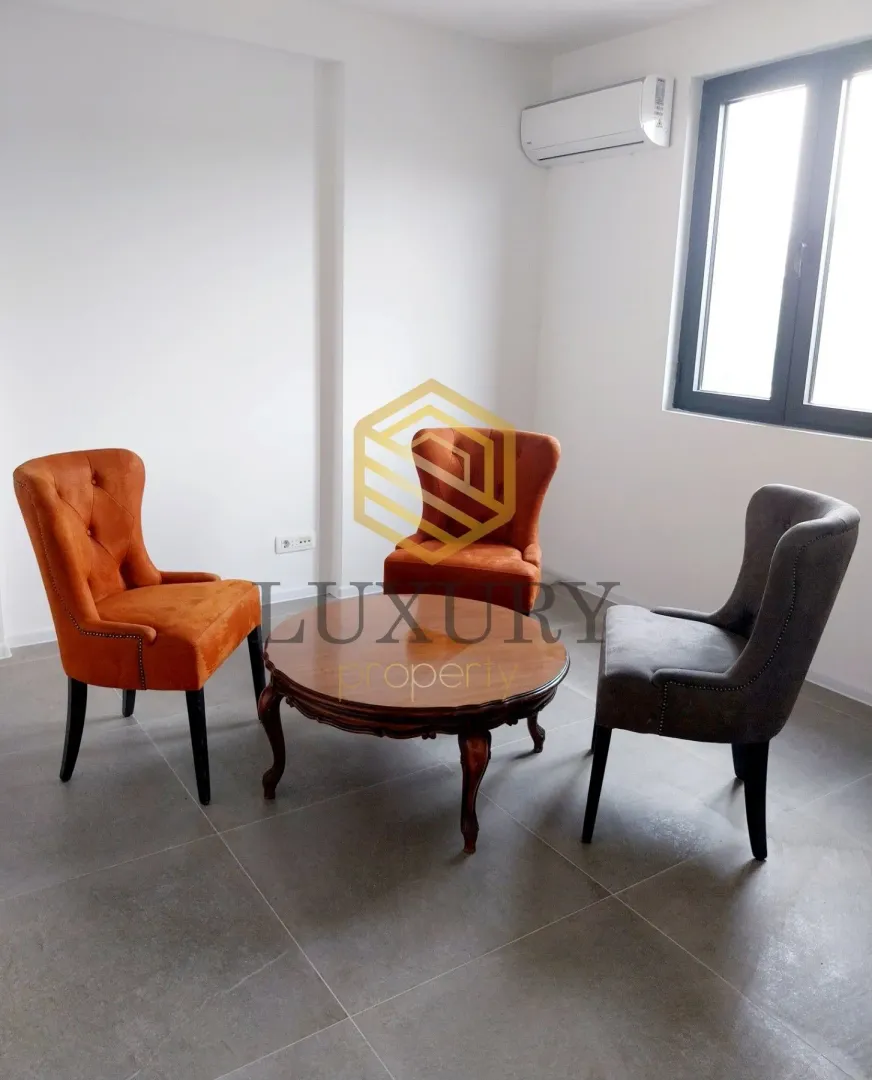 Bright living room with seating furniture and a small table.