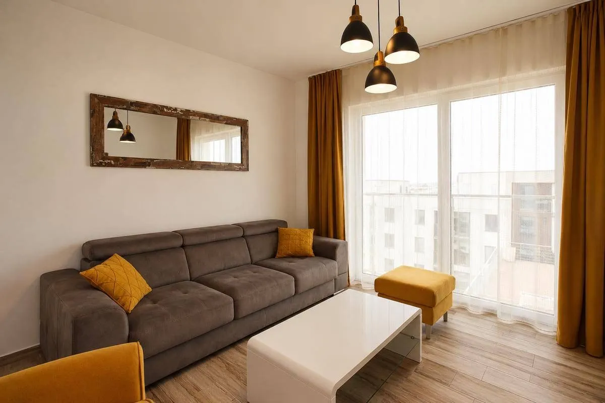 Modern living room with a sofa and a large window.