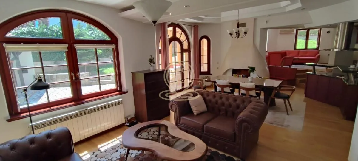 Spacious living room with a dining area and large windows.