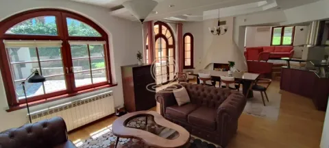 Spacious living room with a dining area and large windows. - image 7