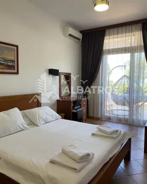 Furnished bedroom with a double bed, desk, and access to the terrace. - image 9