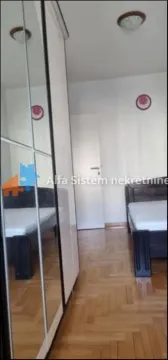 Spavaća soba sa krevetom i ormarom sa ogledalom. - image 7
