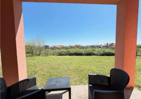 Covered terrace with seating furniture and a view of the yard and surroundings. - image 2