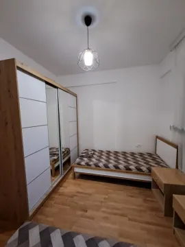 A bedroom with a bed and a large wardrobe. - image 7