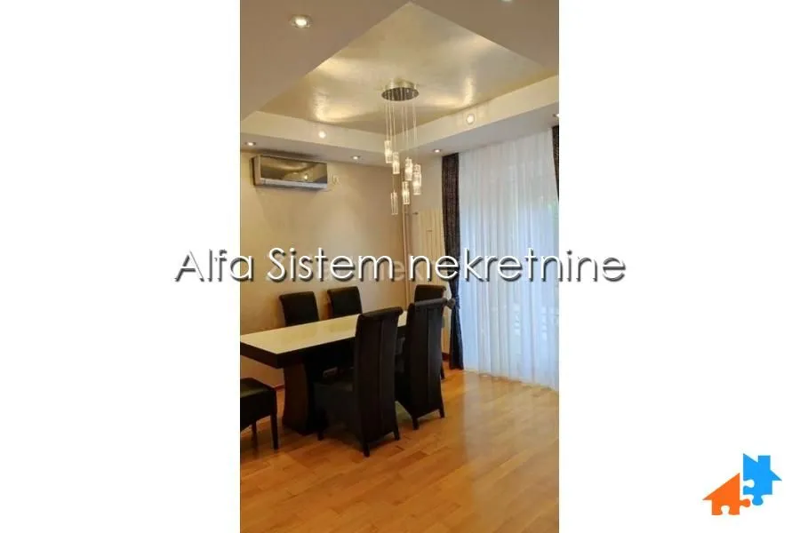 Dining area with a table, chairs, and a dropped ceiling.