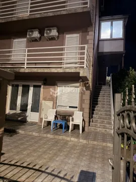 Exterior of the house at night with a yard and stairs. - image 8