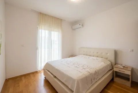 Bright bedroom with a double bed, nightstands, and access to the terrace. - image 9