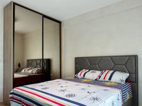 Furnished bedroom with a large double bed and a mirrored wardrobe. - image 5