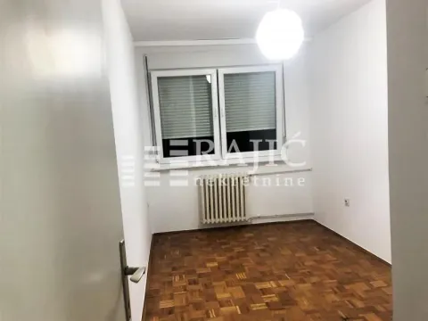Empty room with parquet flooring and a window. - image 6