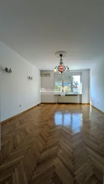 Empty living room with hardwood floors and a chandelier. - image 14