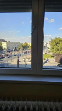 View through the window of the city street and square. - image 8