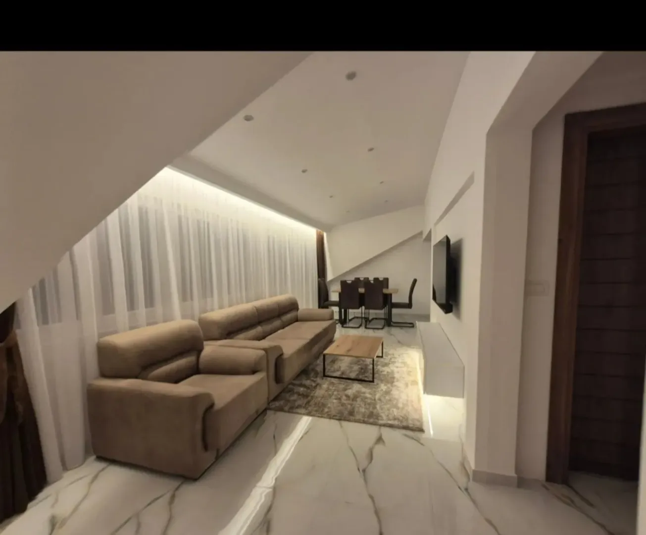 Spacious living room with a sofa set, dining area, and modern lighting.