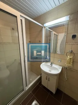 Bathroom with a shower cabin, washbasin, and mirror. - image 7