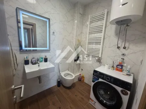 Modern bathroom with washbasin, toilet, washing machine and shower enclosure. - image 4