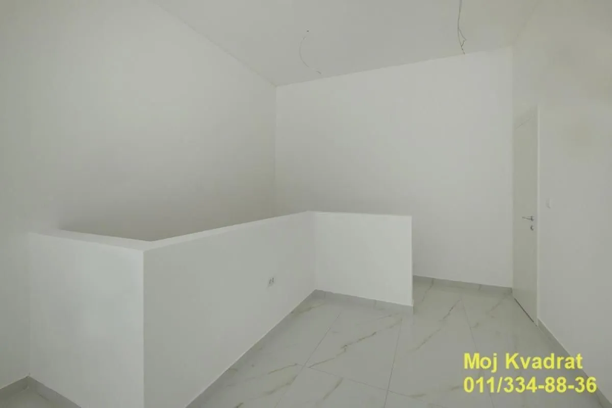 Empty room with white walls and ceramic tile flooring.