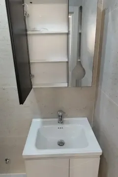 Bathroom with a washbasin, cabinet, and mirror. - image 5
