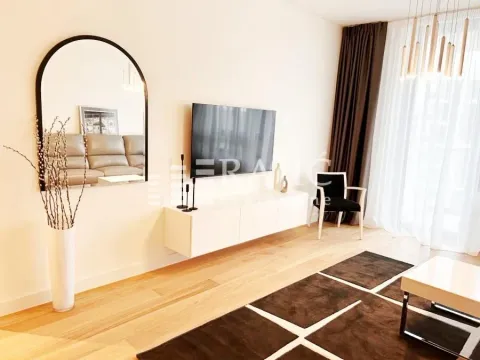 Living room with a sofa, TV, and coffee table. - image 3