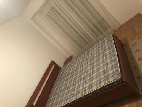 Spavaća soba sa drvenim krevetom i prozorom sa zavjesom. - image 10