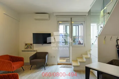 Living room with furniture, television, and stairs leading to the upper floor. - image 2